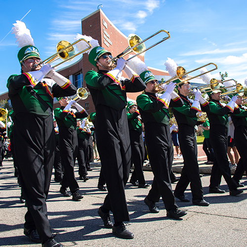 Trombone section in the UAB Band marching during the Homecoming parade.