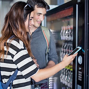 Two students using vending machine.