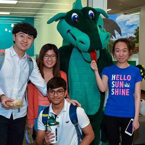 Group of students posing with Blaze.