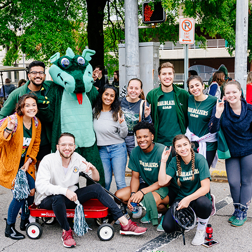 Group of students posing with Blaze.