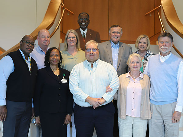 Collat faculty retirees along with their spouses and Dean Jack.