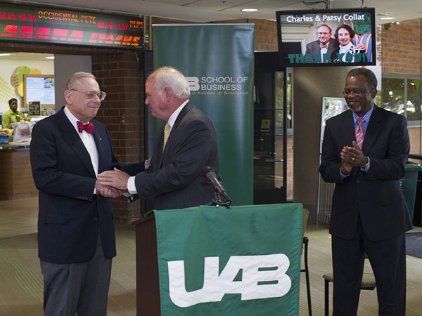 Dr. Watts shaking hands with Charles Collat at the naming of the school. 