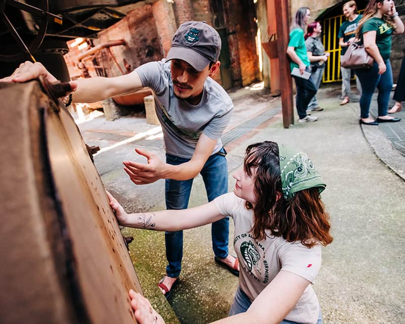 Anthropology teacher instructing student outside at Sloss Furnace.