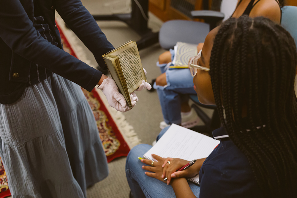 English Major Kaitlin views a 13th century manuscript