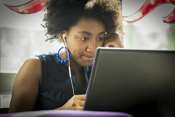 A student with a laptop studying. 