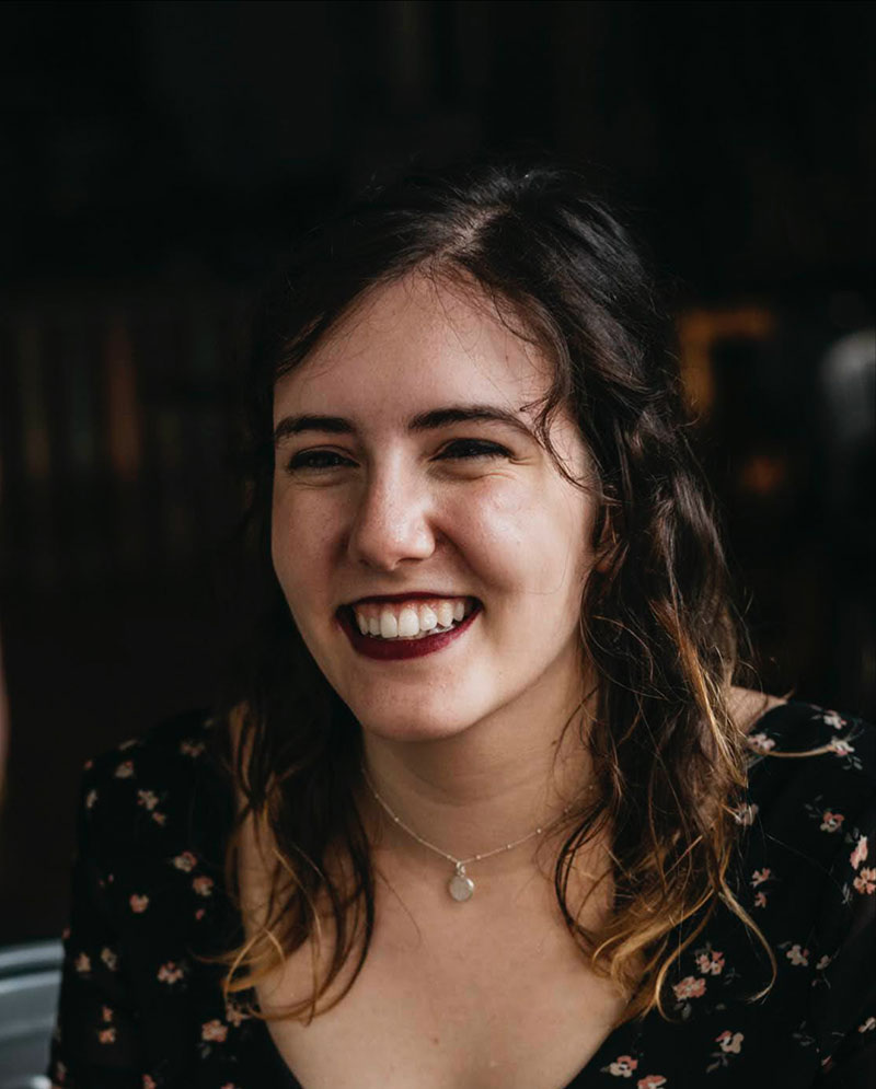 Madison Hogg, a smiling woman wearing a black blouse.