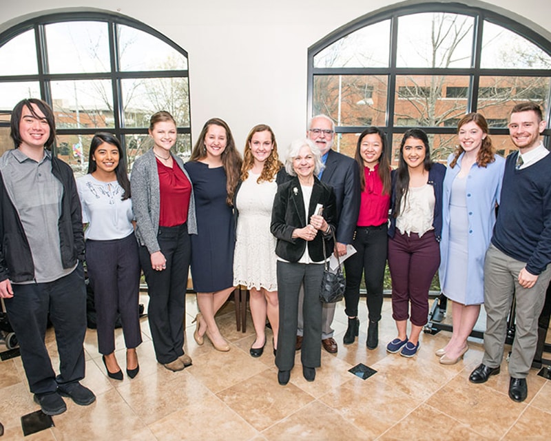 Students celebrating their scholarships with department alumni. 