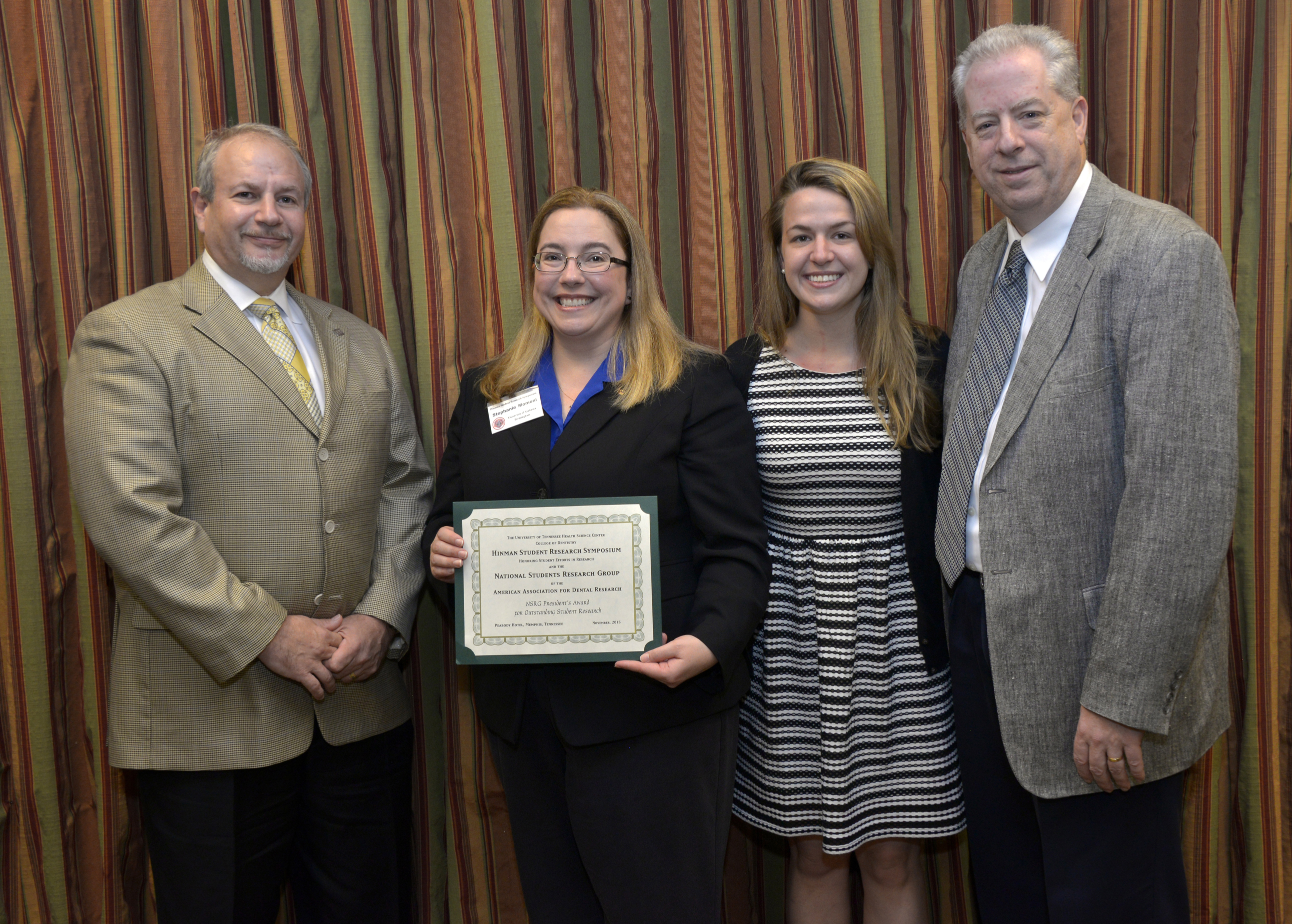 Stephanie Momeni, second from left, won the AADR NSRG President’s Award for Excellence in Research at the 21st Hinman Student Research Symposium.