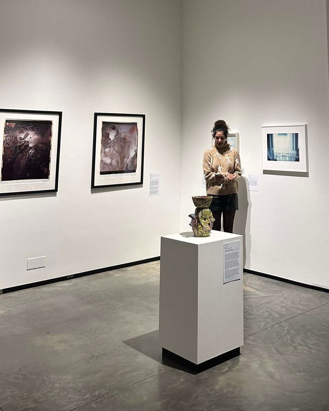 Naomi Ortiz writing a poem based on an exhibition piece in the Abroms-Engel Institute for the Visual Arts. 