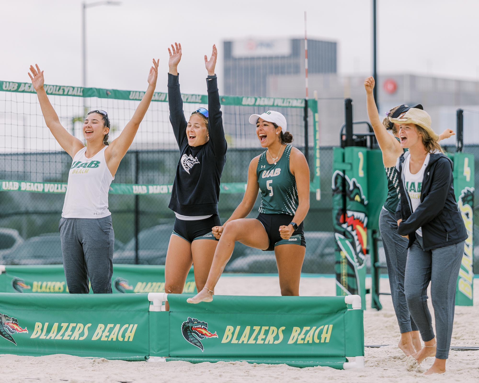 Naomi Ortiz (in green UAB tank top) cheers on her teammates.