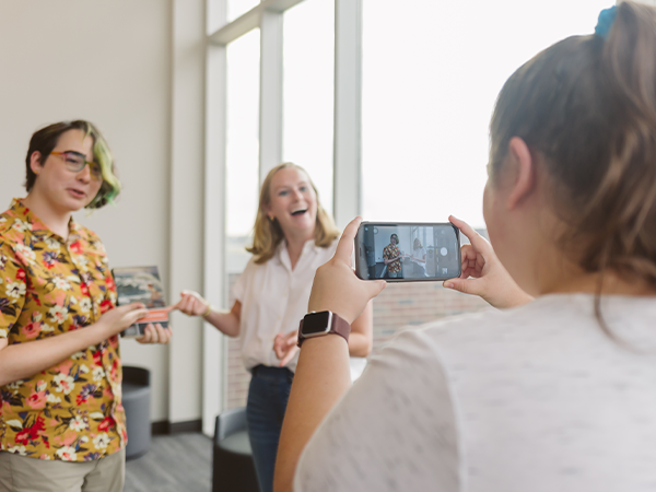 English students pose for a photo taken by their classmate