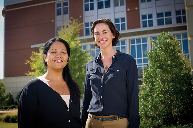 Genevieve Begue and Dr. Sharyn Jones in front of Heritage Hall.