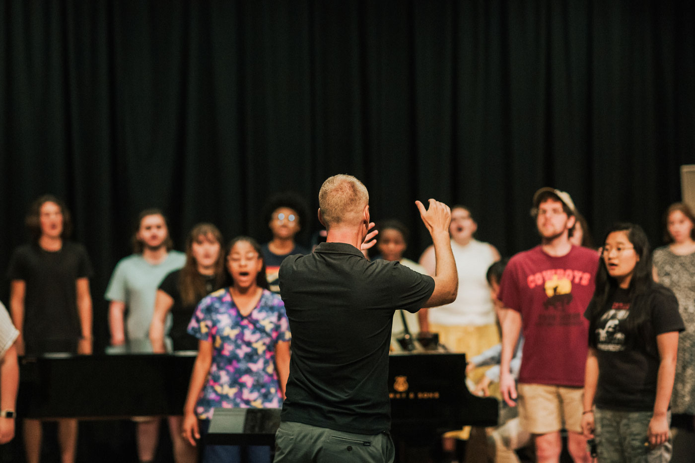 Conductor and choir in rehearsal.