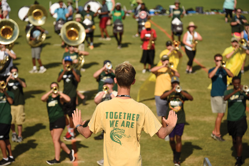 Student conducting the band at band camp.