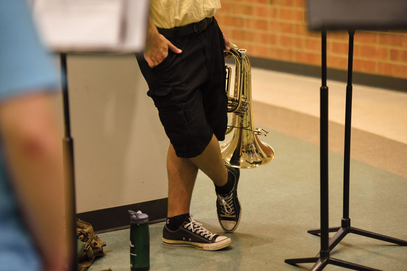 Student holding his baritone horn at band camp.