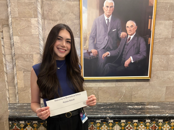 Photo of Alyssa Abbot holding up her name placard