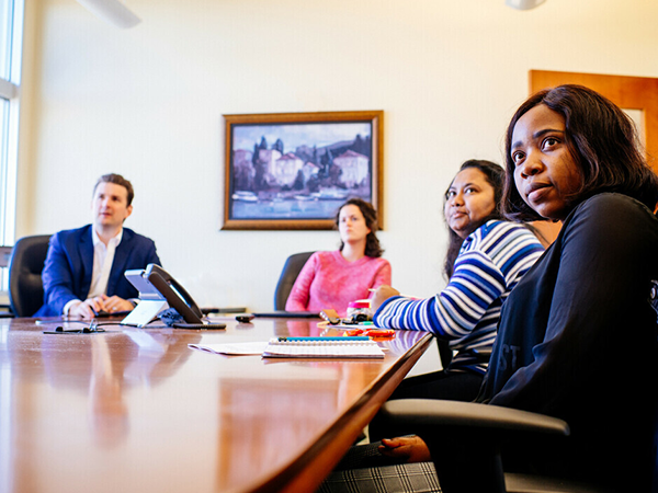 Group shot of sociology faculty watching a presentation in a conference room