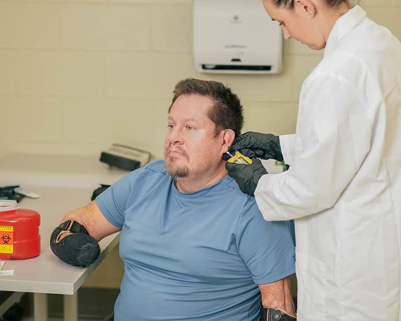 Patient receives an earlobe stick. 