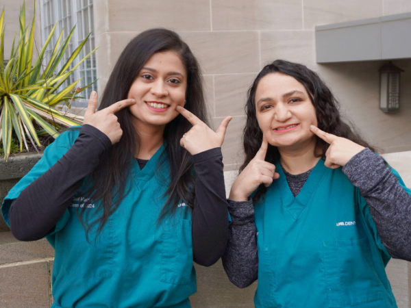 Two dental students smiling