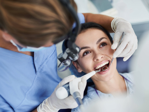 Adobe Stock image of woman opening mouth for dentist