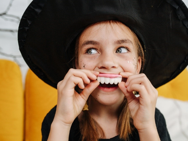 Adobe stock photo of girl with prop teeth