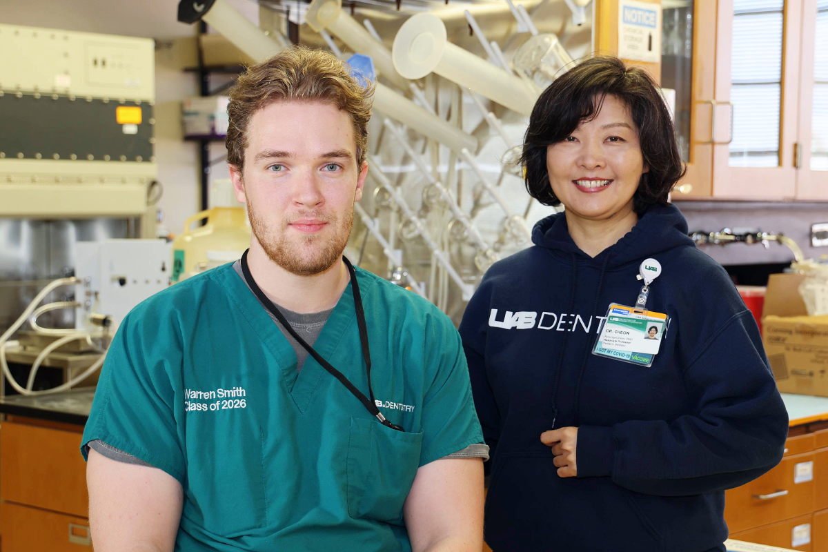 Dr. Cheon standing next to Warren Smith (sitting) in the School of Dentistry dental research lab.