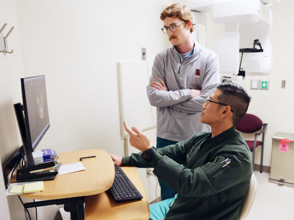 Dr. Le and Jack Shepherd discussing an x-ray in the OMFS clinic at the UAB School of Dentistry