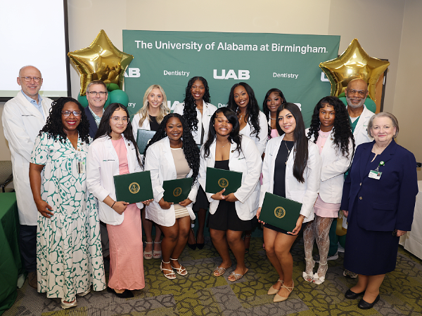 Group photo of dental assisting program graduates with faculty and staff