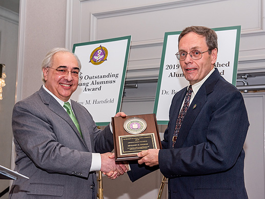 Dr. Ingram receives the award.