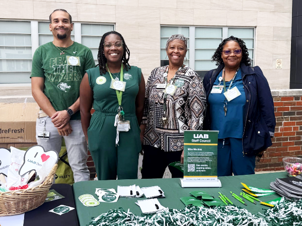 Group photo of four SOD staff council members tabling outside the school