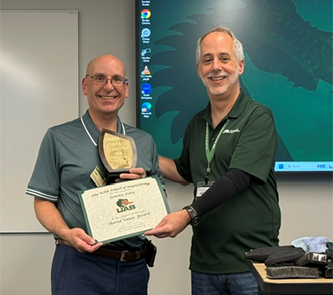 Tommy Foley presented a certificate and plaque by Dean Jeff Holmes