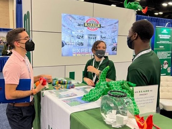 3 people taking at the UAB booth.