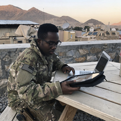 Jackson in the field doing homework.