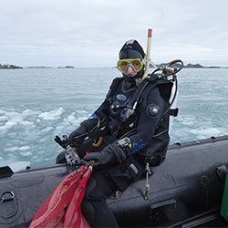 Sabrina Heiser on a boat in scuba gear.