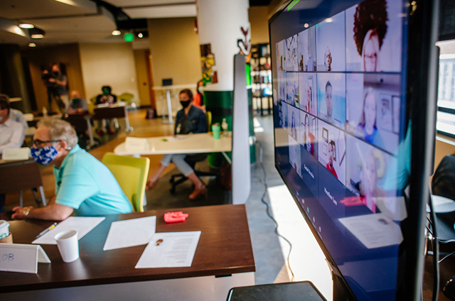 Photo of classroom with Zoom screen in background