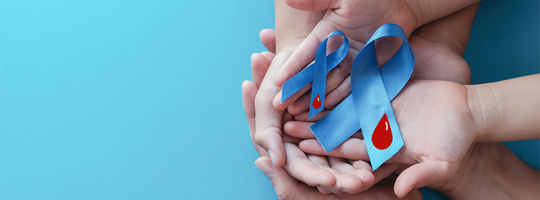 Two sets of hands holding diabetes ribbons