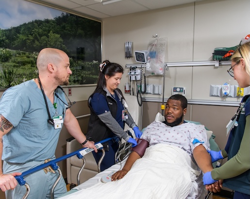 uab emergency medicine doctor talking to patient at bedside