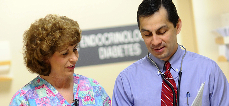 Dr. Ovalle discusses patient care with a nurse.