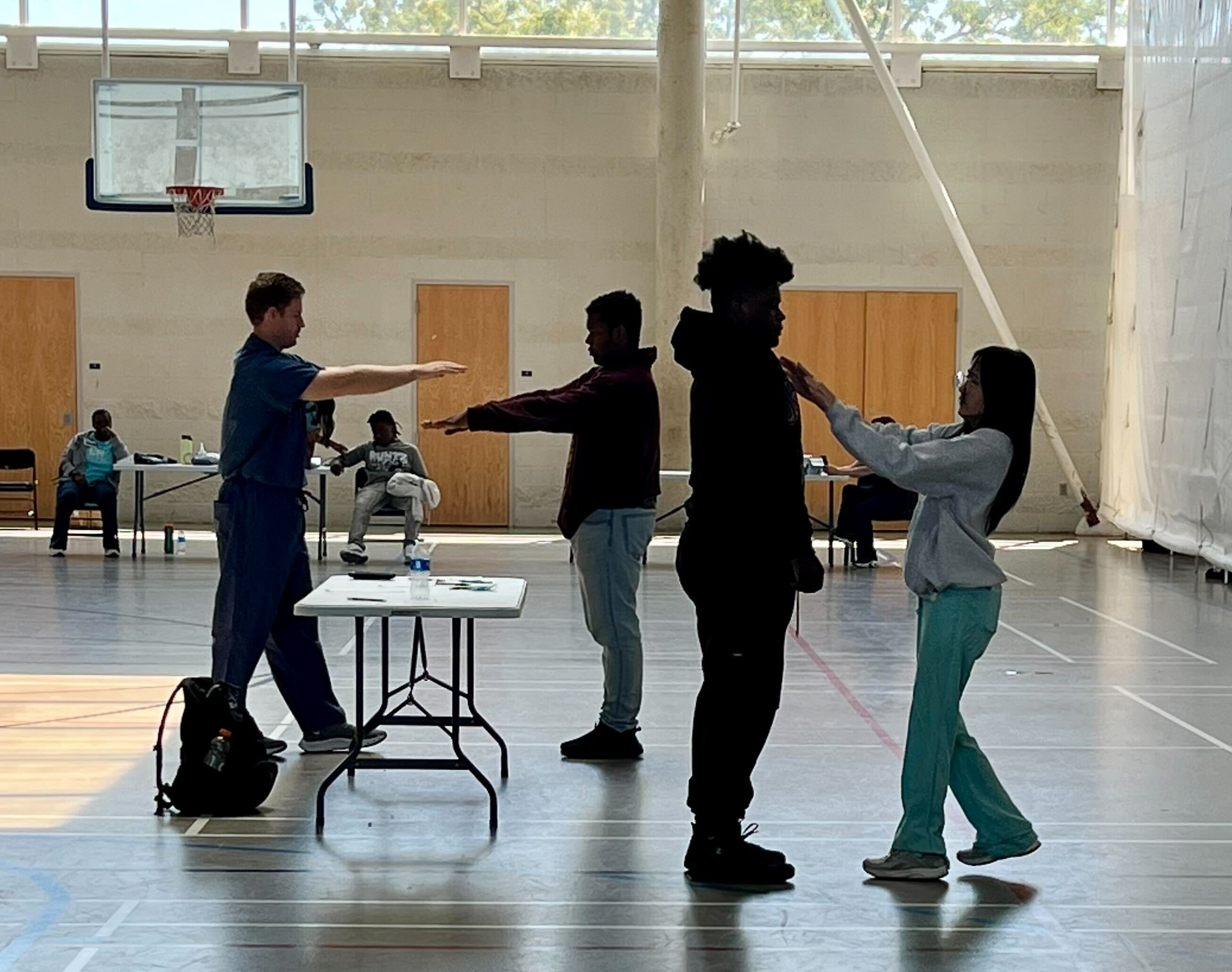 UAB Optometry volunteers performing eye exams on student-athletes.