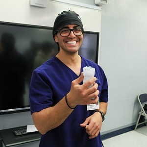 Grijalba holds up a POCUS device