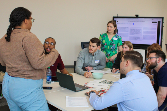 CU2RE Director Jill Marsh listens in on retreat attendees during an interprofessional exercise.