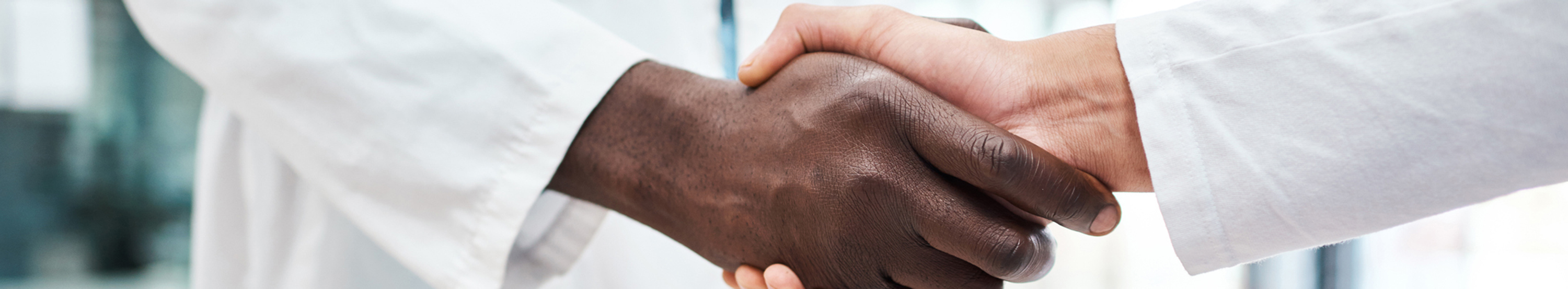 image of two doctors in white coats shaking hands