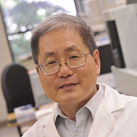 Close-up of Dr. Moon Nahm, MD (Professor, Laboratory Medicine) sitting in hospital.