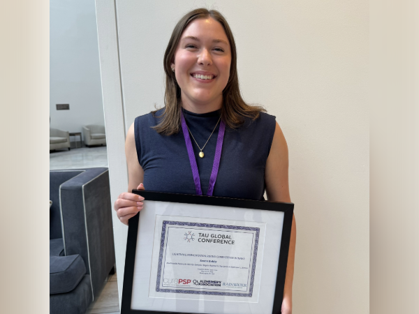 Emma Hobby, UAB GBS student, holding award