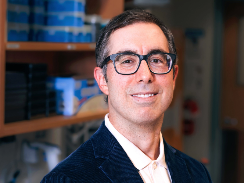 Headshot of Jeremy Herskowitz, Ph.D., standing in front of a bookshelf.