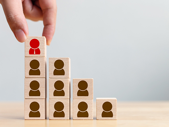 Human resource and talent management and recruitment business concept, Hand putting wood cube block on top staircase