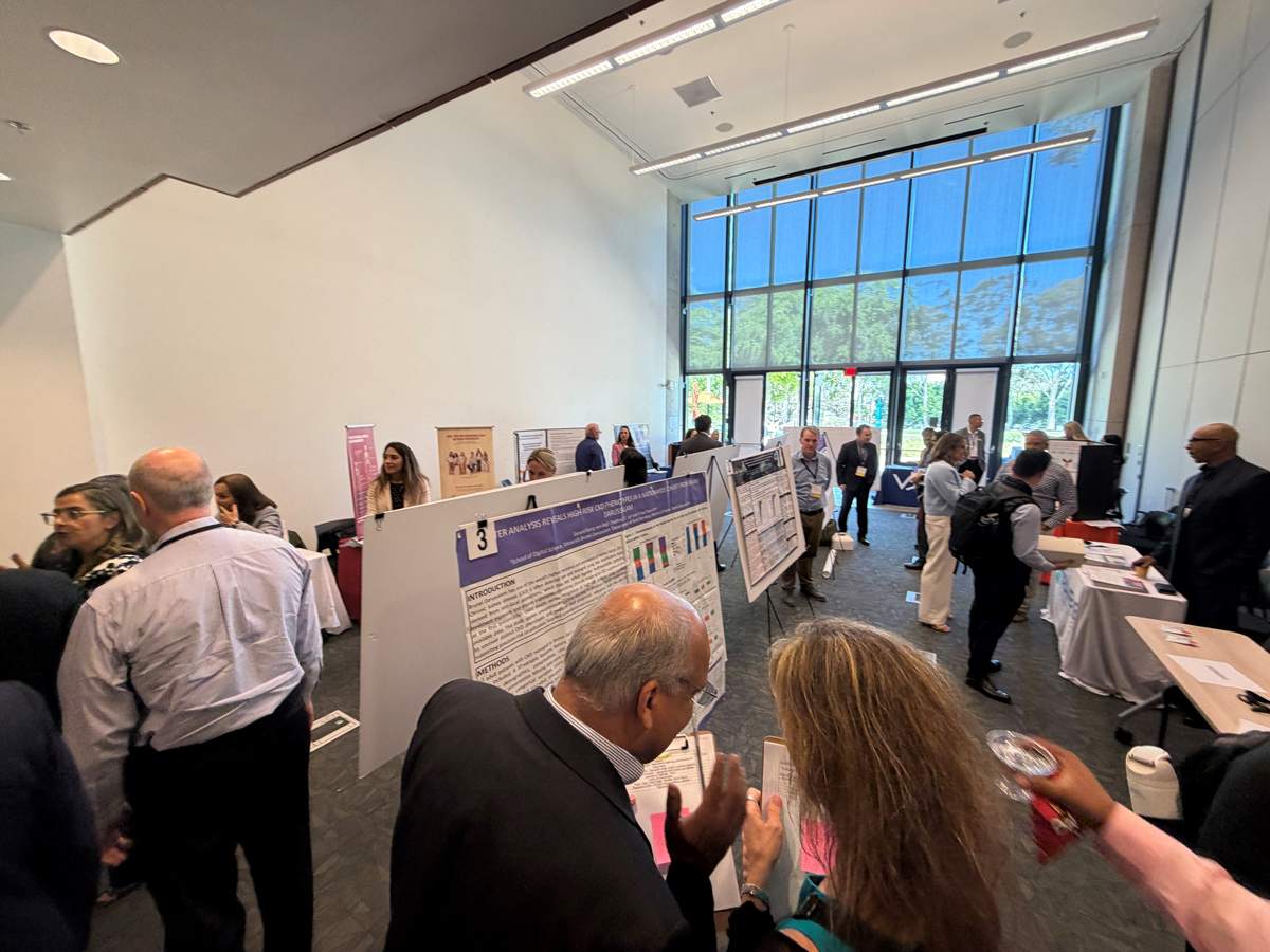 A group of people attending a poster session.