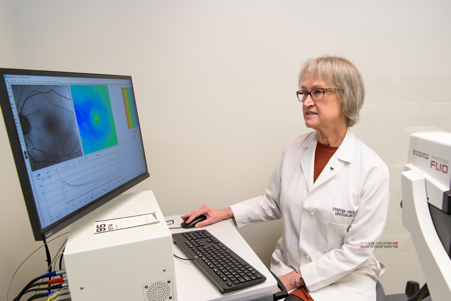 Dr. Owsley showing a close look of a cornea on a computer screen.