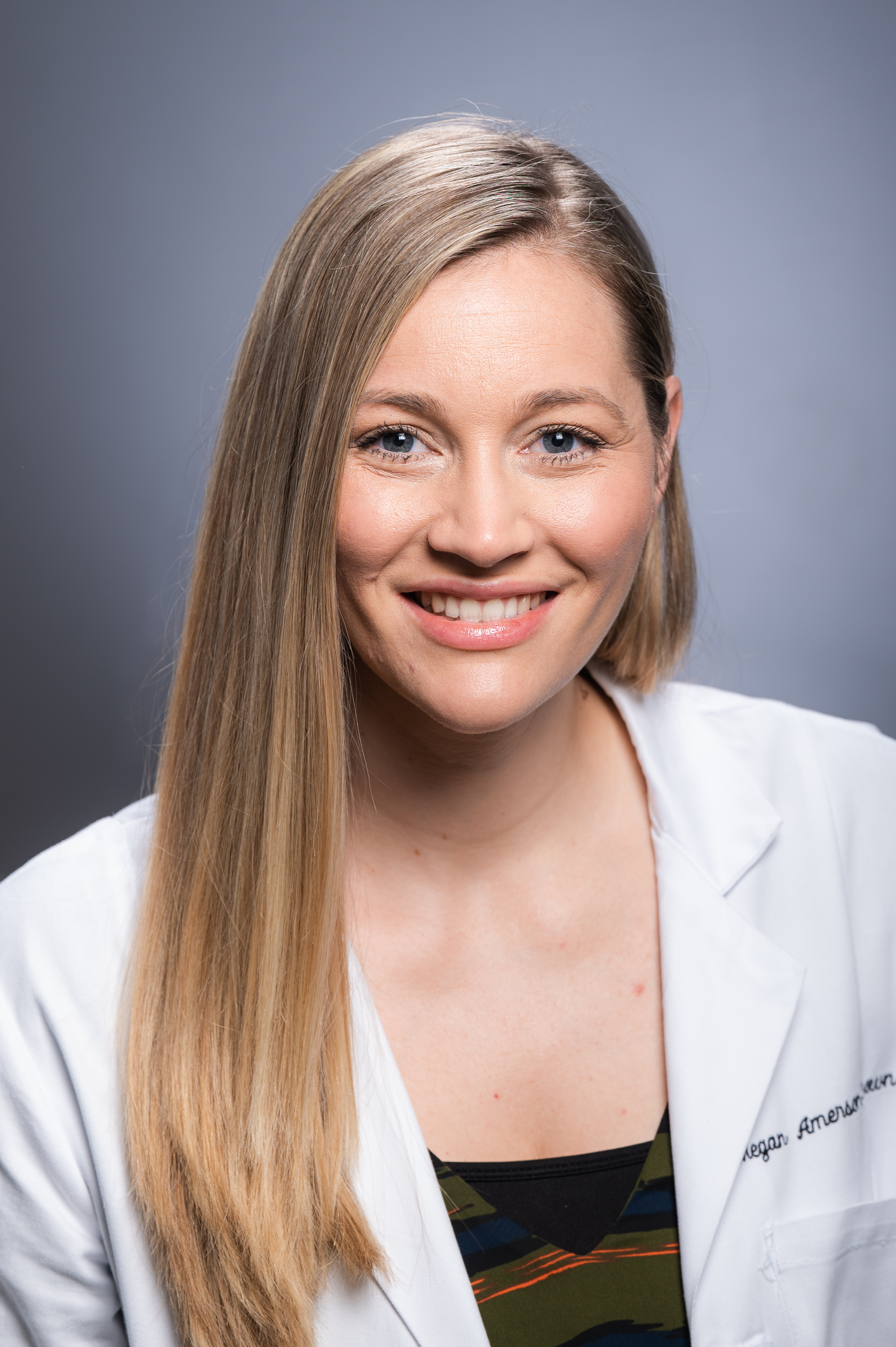 Headshot of Dr. Megan Amerson-Brown, PhD (Assistant Professor, Laboratory Medicine) in white medical coat, August 2022.