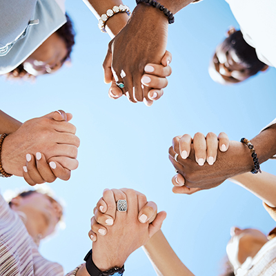  group holding hands to show comfort